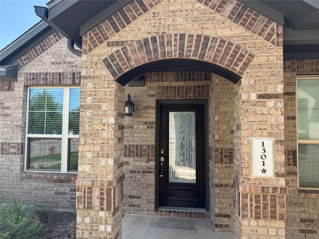 7220 Wyoming Springs Drive, Unit 1301 Round Rock, TX 78681 - Photo 2 of 21 a front view of a house with glass windows