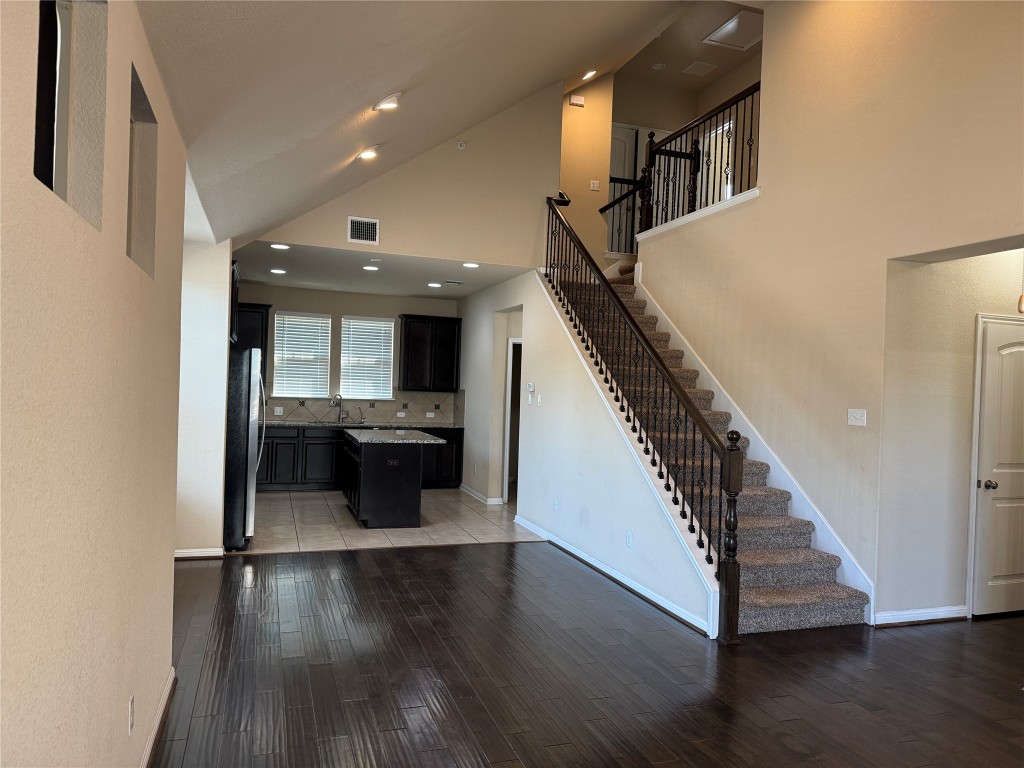 7220 Wyoming Springs Drive, Unit 1301 Round Rock, TX 78681 - Photo 5 of 21 a room with wooden floors and stairs