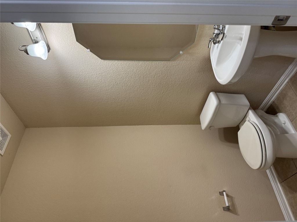 7220 Wyoming Springs Drive, Unit 1301 Round Rock, TX 78681 - Photo 9 of 21 a bathroom with a toilet sink and mirror
