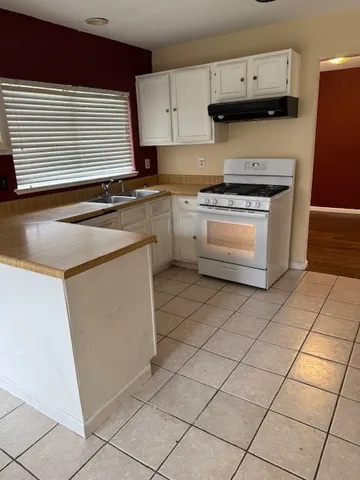 a kitchen with cabinets and appliances