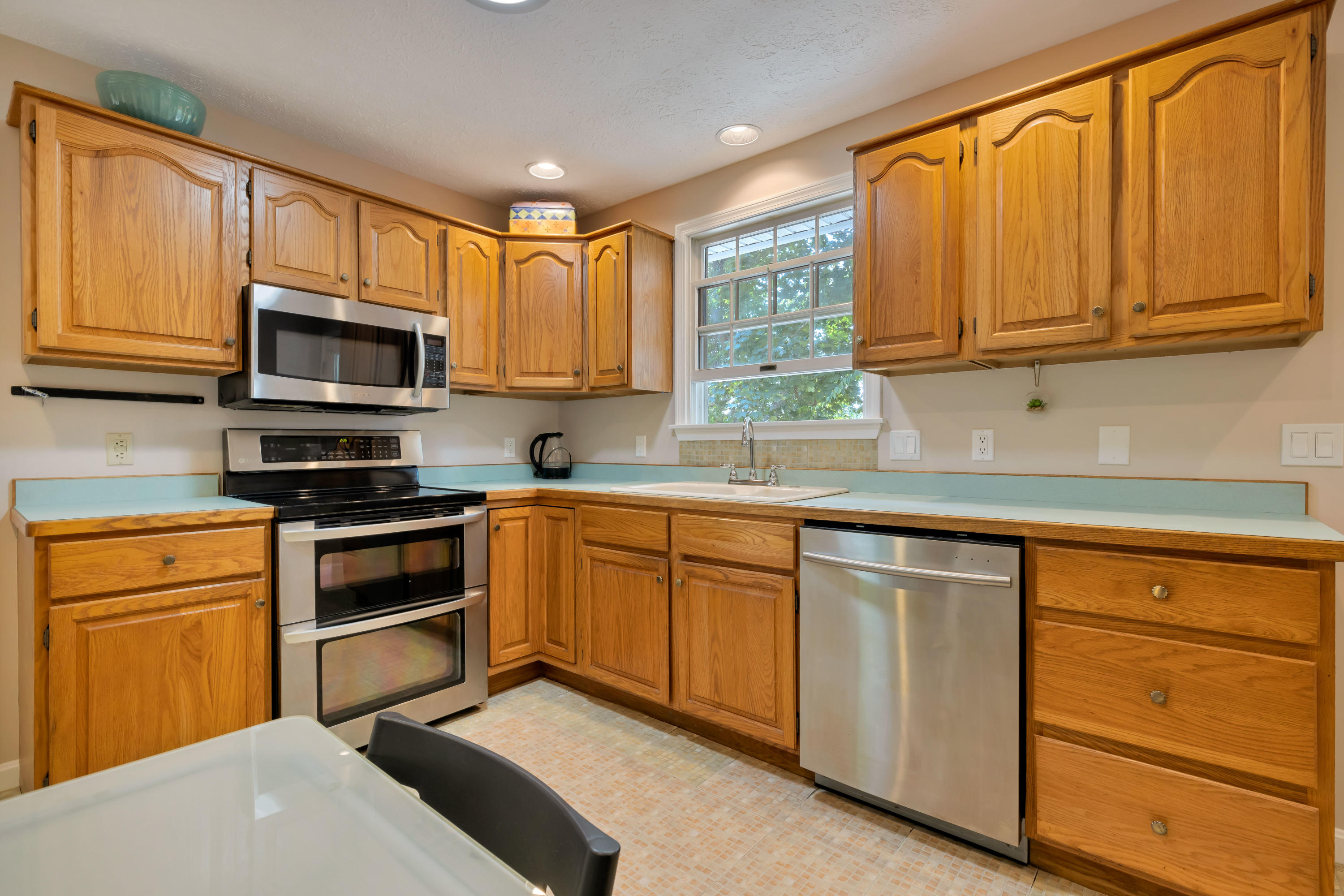 9 Green Pond Road East Falmouth, MA 02536 - Photo 11 of 46 a kitchen with granite countertop cabinets stainless steel appliances and a sink