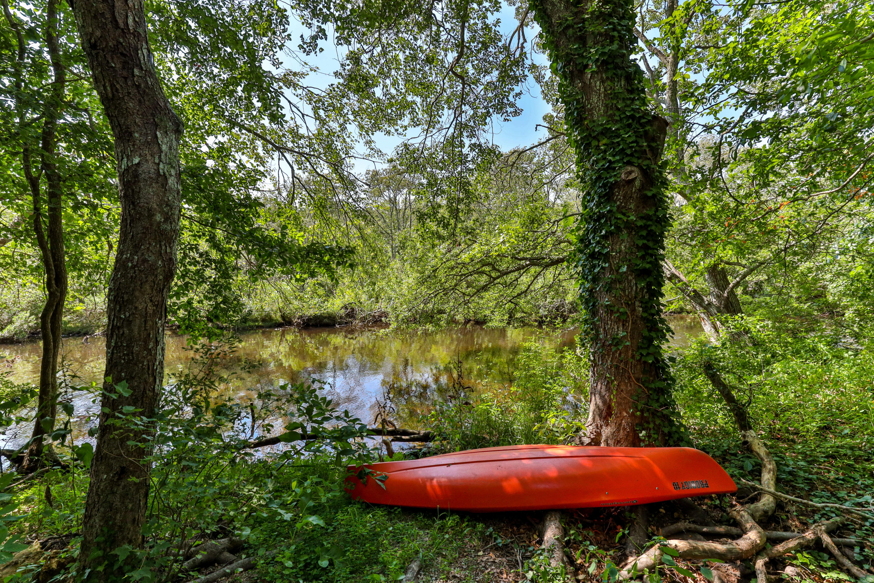 9 Green Pond Road East Falmouth, MA 02536 - Photo 34 of 46 a view of a red and white house with a yard