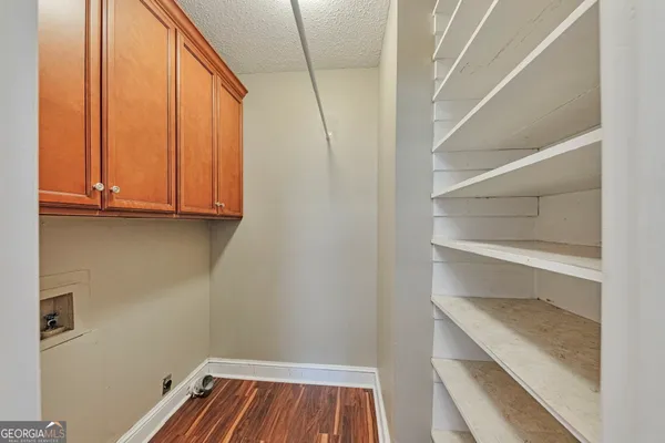 a view of walk in closet with empty racks