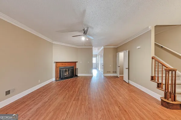 a view of empty room with wooden floor
