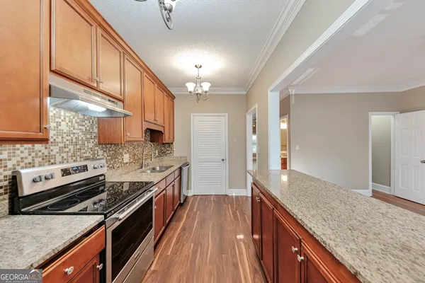 a kitchen with stainless steel appliances granite countertop a stove and a sink