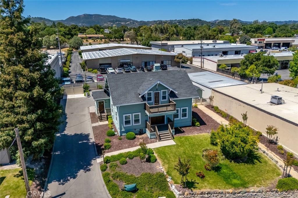 an aerial view of a house with garden space and street view