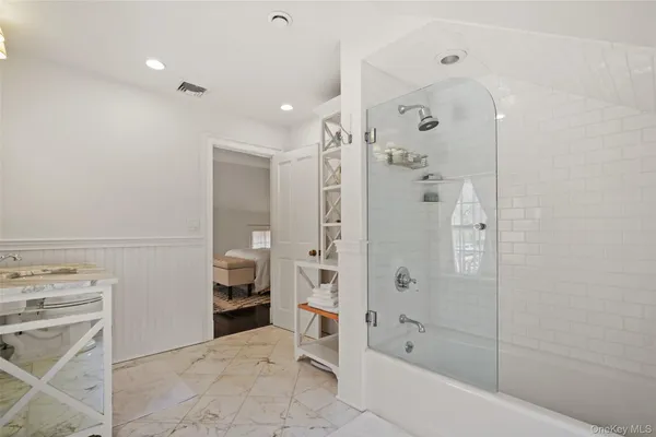 a bathroom with a bathtub and a shower