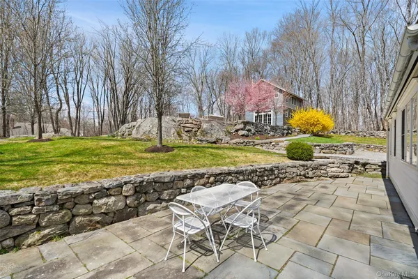 a view of a swimming pool with a patio and a yard