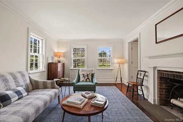 a living room with furniture a fireplace and next to a window