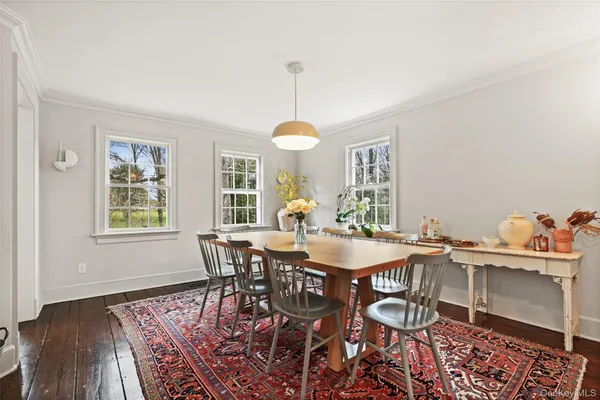 a dining room with furniture a chandelier and wooden floor