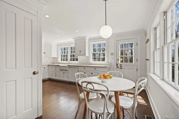 a view of a dining room with furniture window and wooden floor