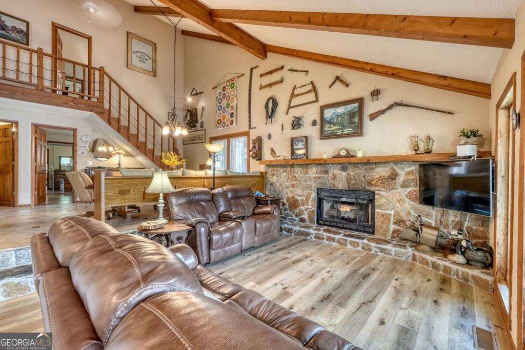 241 Kilpatrick Point Drive, Unit 8 Hayesville, NC 28904 - Photo 14 of 54 a living room with furniture a fireplace and a flat screen tv