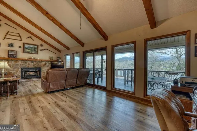 a living room with furniture and a kitchen view
