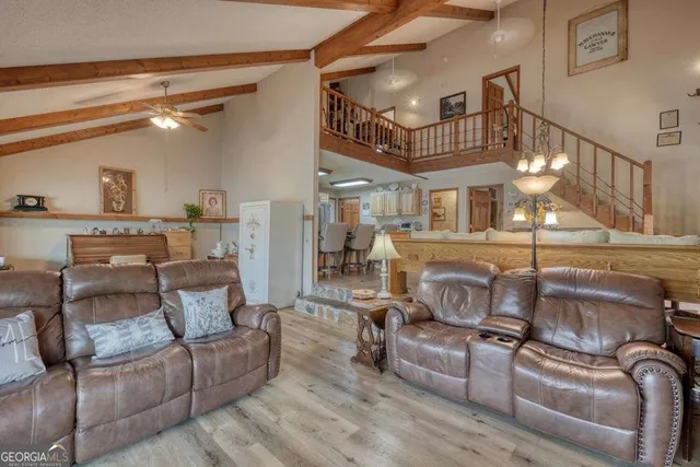 a view of a dining room with furniture and a chandelier