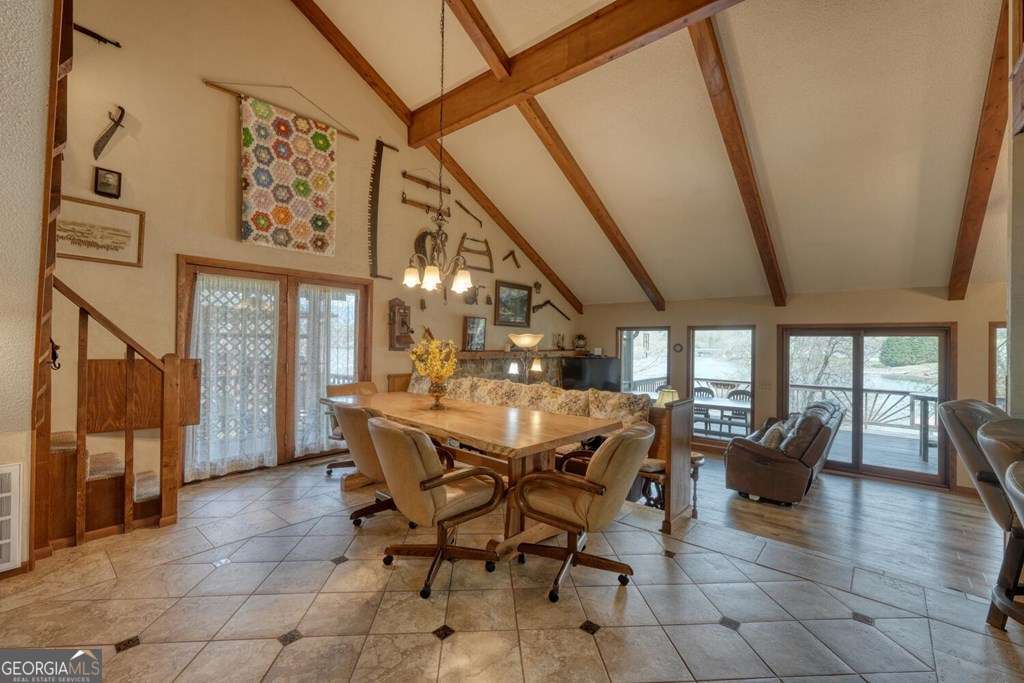241 Kilpatrick Point Drive, Unit 8 Hayesville, NC 28904 - Photo 18 of 54 a view of a dining room with furniture and a chandelier
