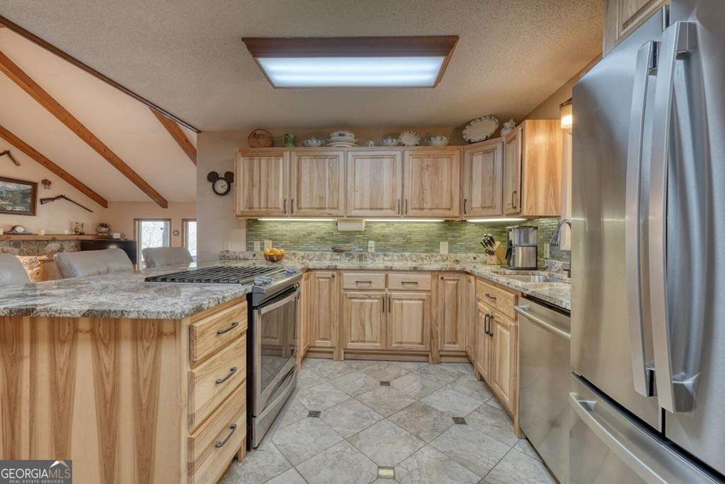 241 Kilpatrick Point Drive, Unit 8 Hayesville, NC 28904 - Photo 20 of 54 a kitchen with stainless steel appliances granite countertop a stove a sink and a refrigerator
