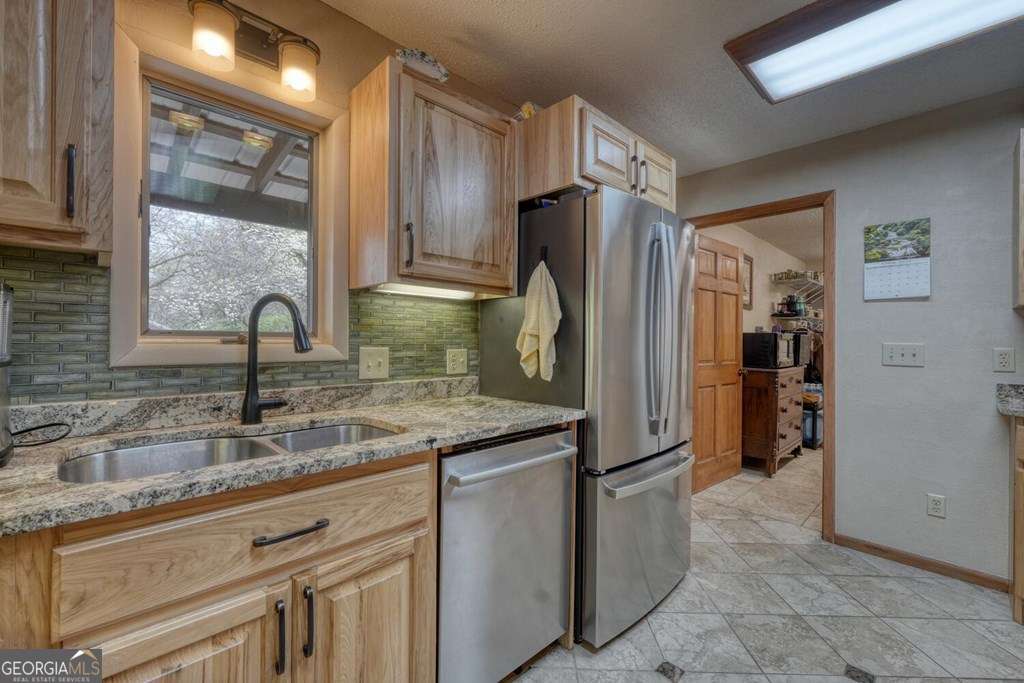 241 Kilpatrick Point Drive, Unit 8 Hayesville, NC 28904 - Photo 21 of 54 a kitchen with stainless steel appliances granite countertop a refrigerator and a sink