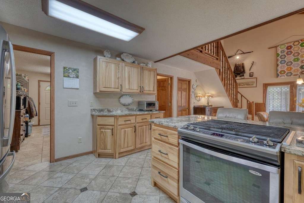 241 Kilpatrick Point Drive, Unit 8 Hayesville, NC 28904 - Photo 22 of 54 a kitchen with stainless steel appliances granite countertop a stove and a sink