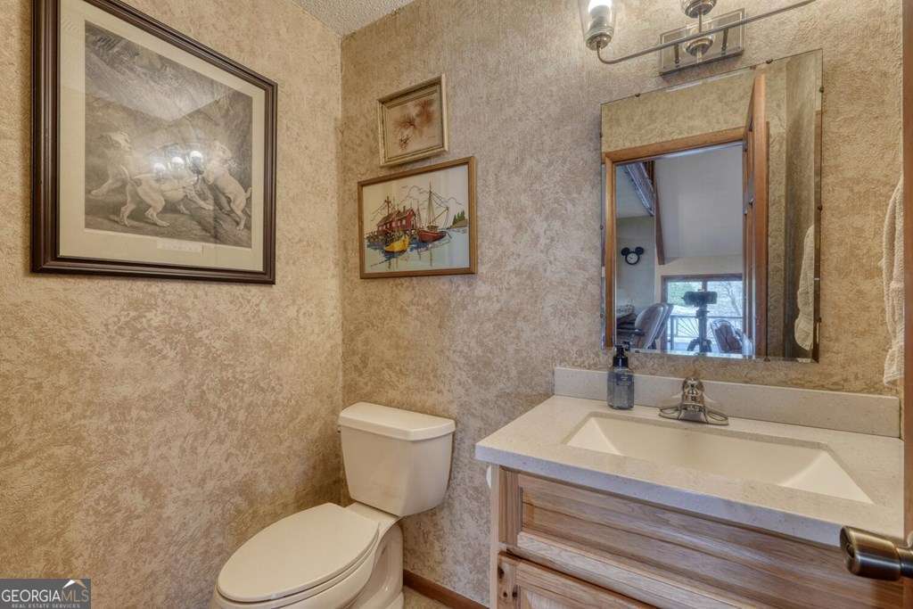 241 Kilpatrick Point Drive, Unit 8 Hayesville, NC 28904 - Photo 23 of 54 a bathroom with a sink mirror vanity and a toilet