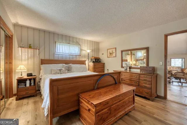 a bedroom with a large bed and a large mirror