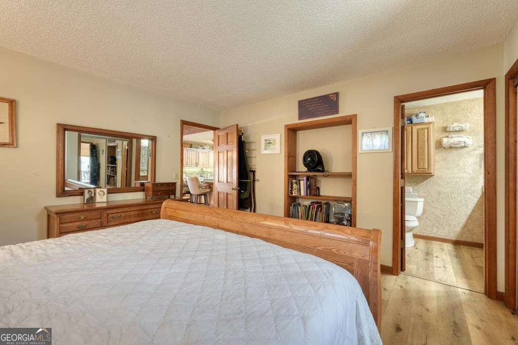 241 Kilpatrick Point Drive, Unit 8 Hayesville, NC 28904 - Photo 26 of 54 a bedroom with a large bed and a large mirror