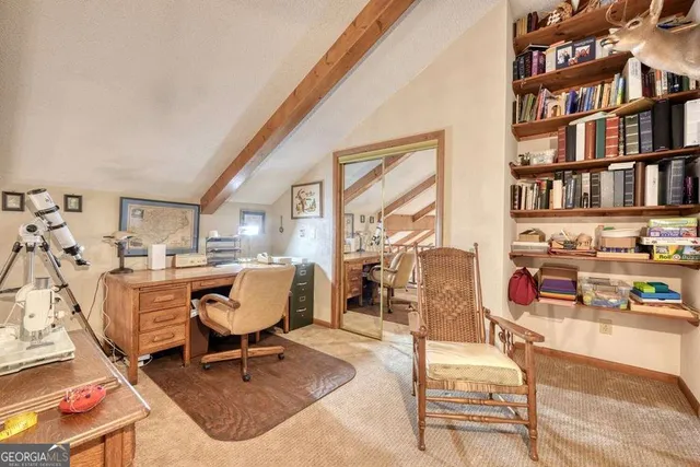 a spacious bedroom with a bed and a mirror