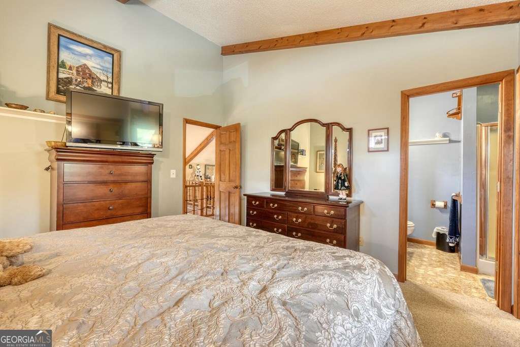 241 Kilpatrick Point Drive, Unit 8 Hayesville, NC 28904 - Photo 32 of 54 a bedroom with a bed and a dresser