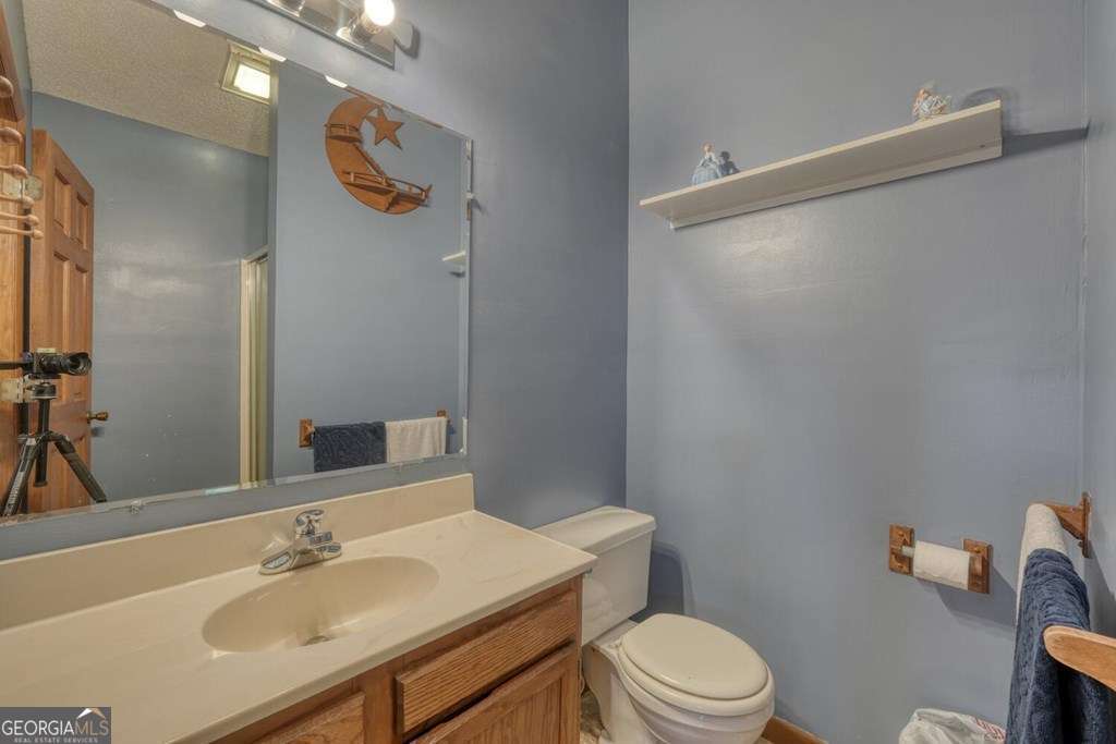 241 Kilpatrick Point Drive, Unit 8 Hayesville, NC 28904 - Photo 33 of 54 a bathroom with a sink a toilet a mirror and shower