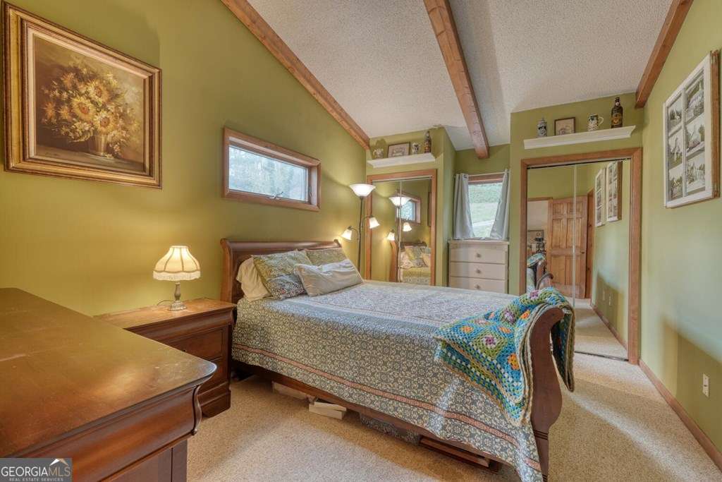 241 Kilpatrick Point Drive, Unit 8 Hayesville, NC 28904 - Photo 34 of 54 a bedroom with a bed and window