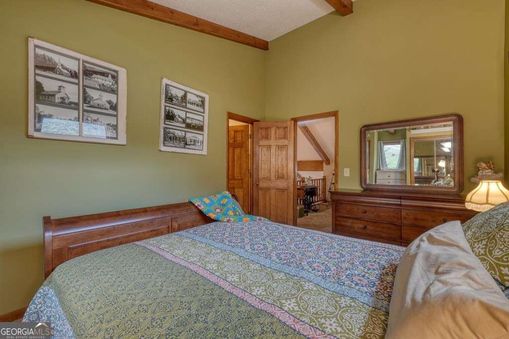 241 Kilpatrick Point Drive, Unit 8 Hayesville, NC 28904 - Photo 35 of 54 a bedroom with a bed and wooden floor