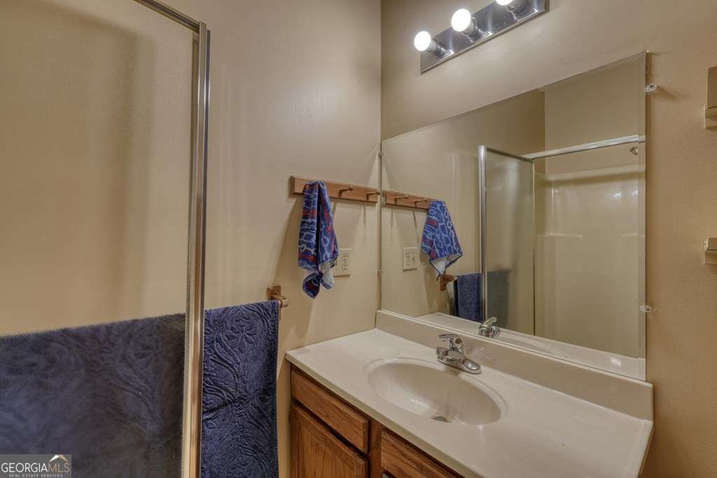 241 Kilpatrick Point Drive, Unit 8 Hayesville, NC 28904 - Photo 36 of 54 a bathroom with a sink vanity granite and a mirror