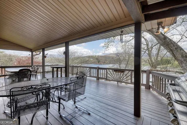 a balcony with chairs and wooden floor