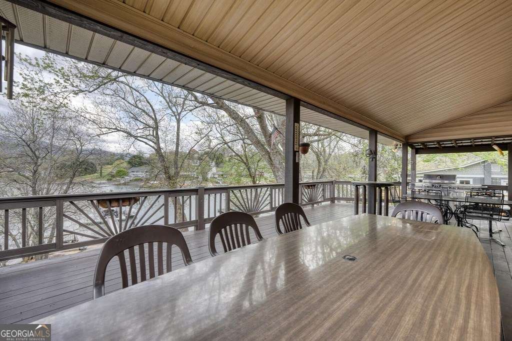 241 Kilpatrick Point Drive, Unit 8 Hayesville, NC 28904 - Photo 40 of 54 a balcony with chairs and wooden floor