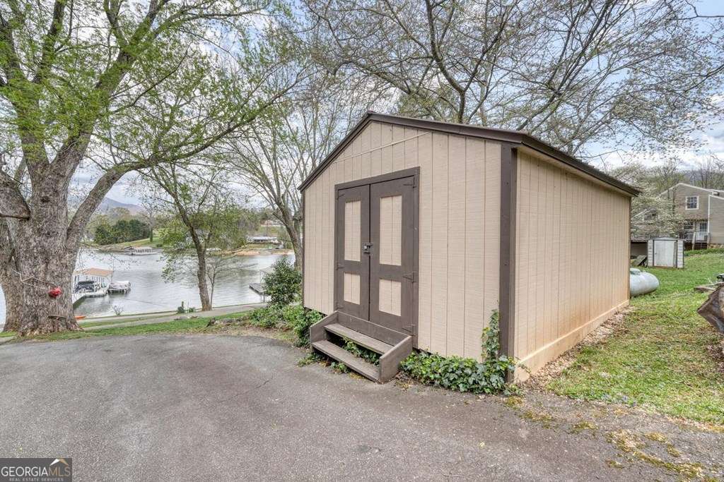 241 Kilpatrick Point Drive, Unit 8 Hayesville, NC 28904 - Photo 45 of 54 a view of a house with a yard and garage