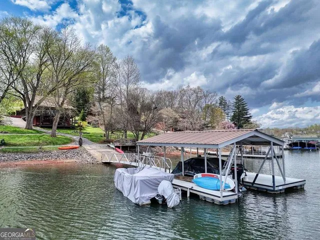 a view of house with swimming pool and outdoor seating