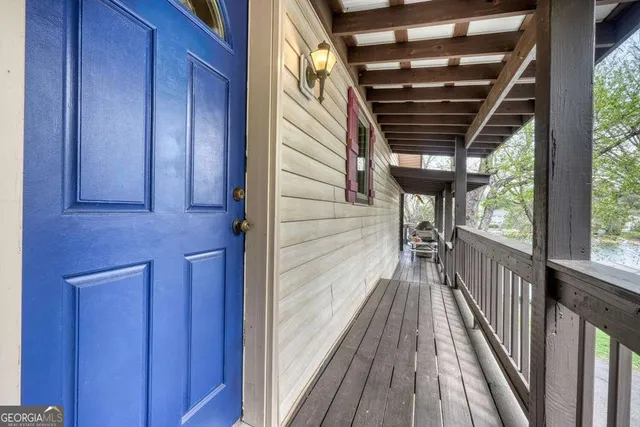 a view of balcony with wooden floor and fence
