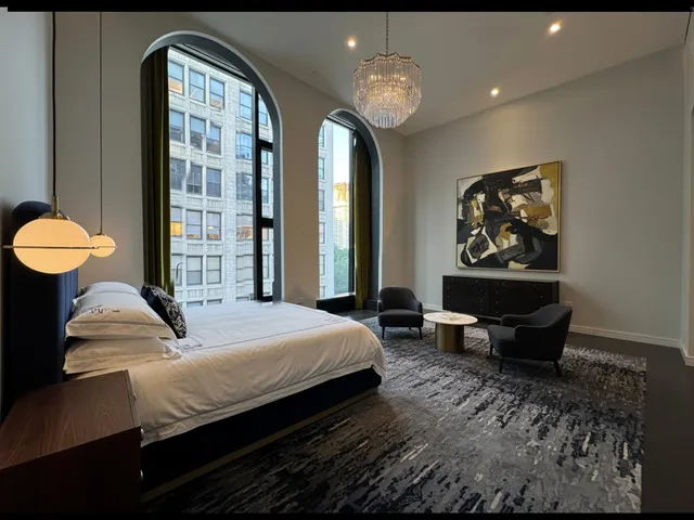 a bedroom with bed and wooden floor