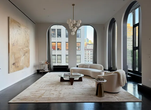 a living room with furniture chandelier and a large window