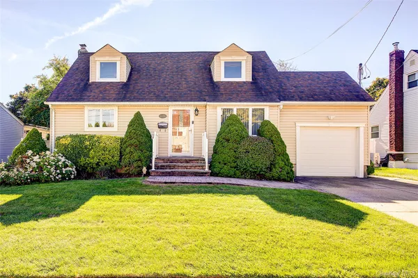 a view front of houses with a yard