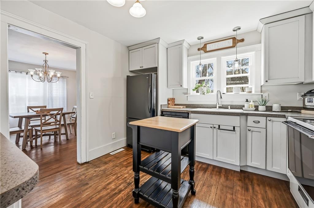 1034 Myrtle Place Sharon, PA 16146 - Photo 11 of 31 a kitchen with a table chairs refrigerator and cabinets
