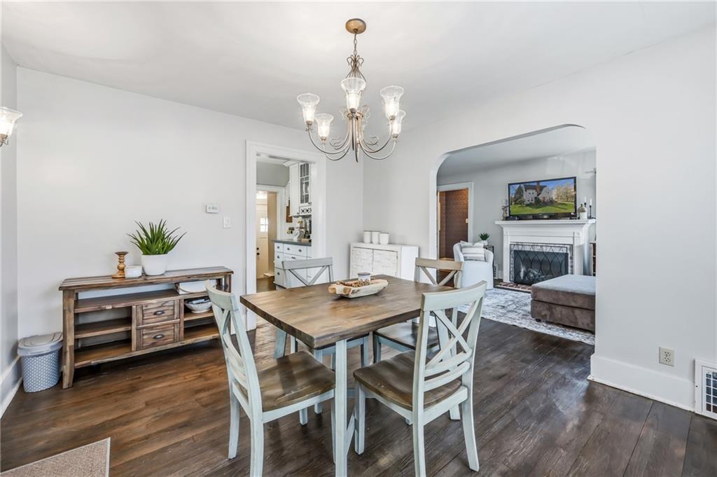1034 Myrtle Place Sharon, PA 16146 - Photo 10 of 31 a dining room with wooden floor a chandelier a wooden table and chairs