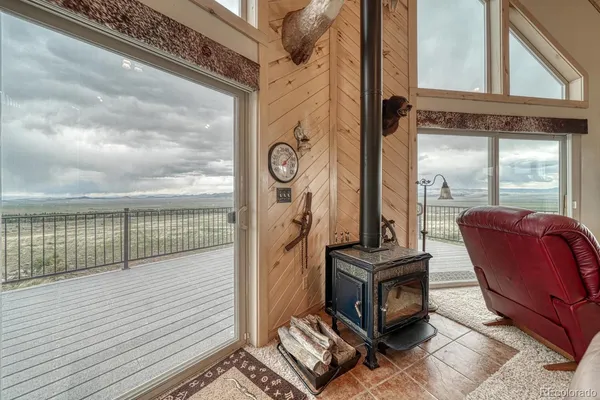 a living room with furniture a flat screen tv and a large window
