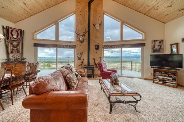a room with furniture a flat screen tv and a window