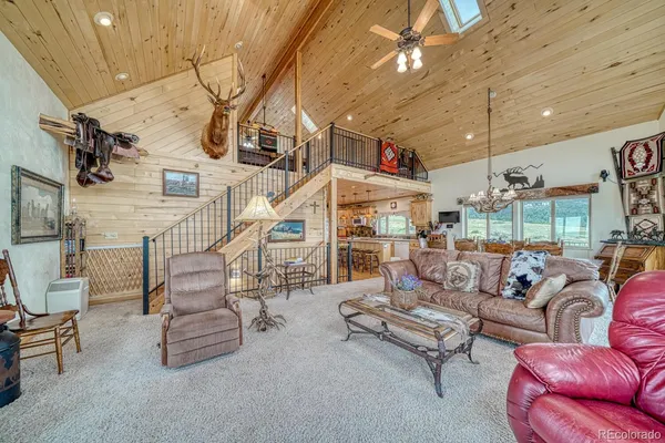a room with lots of furniture and a chandelier