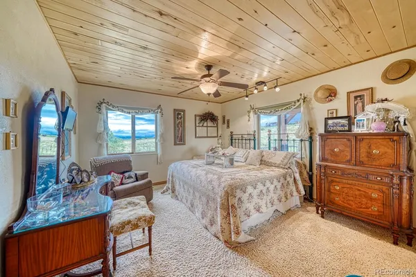 a bedroom with furniture and a chandelier