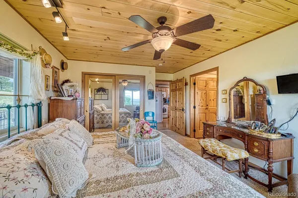 a view of staircase with lots of frames on wall and a flat tv screen