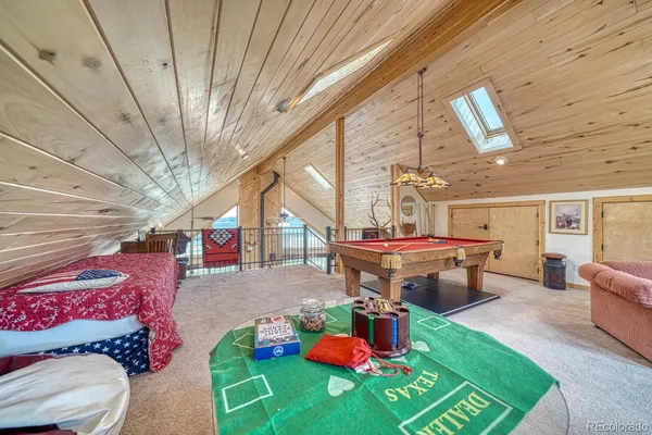 a bedroom with a bed and a large mirror on the dresser