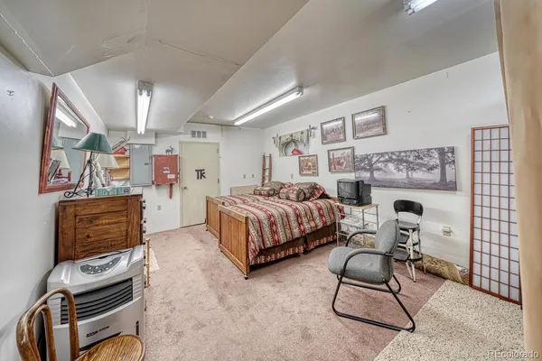 a spacious bedroom with a bed closet and flat screen tv