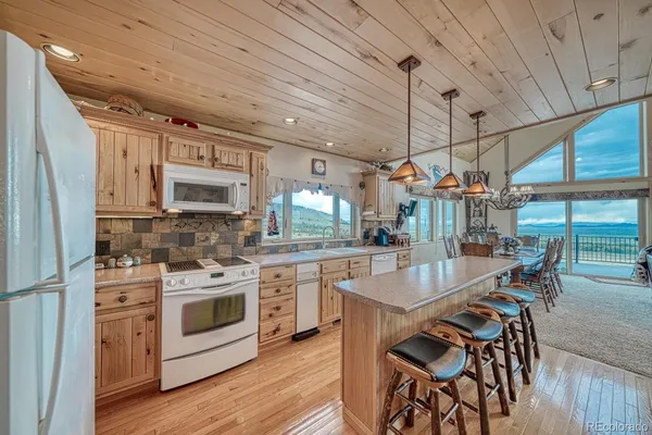 a kitchen with cabinets and wooden floor