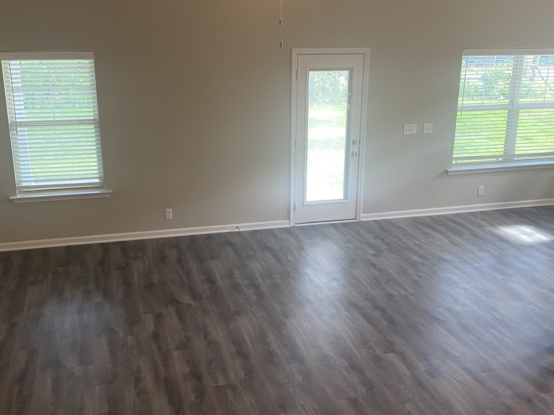 247 Ruby Cate Way Murfreesboro, TN 37128 - Photo 4 of 10 an empty room with wooden floor and windows